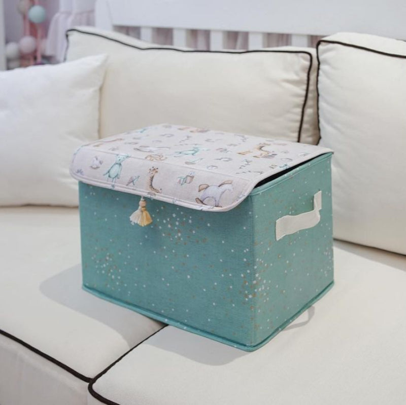 Teal fabric storage box with lid and handles – nursery toy organizer”
“Nursery storage box in teal fabric with golden stars and tassel detail”
“Large teal fabric bin with illustrated lid for toys and baby clothes”
“Decorative teal nursery storage chest with cute baby prints”
“Fabric toy and blanket organizer with lid – teal and gold design”