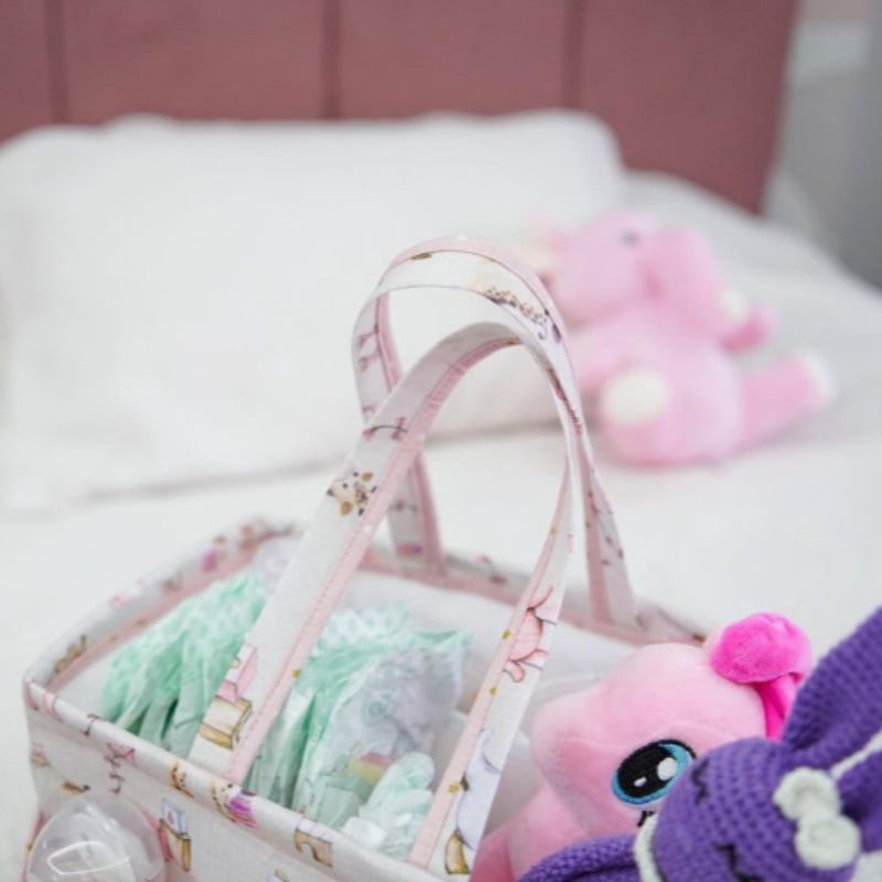Pink baby care caddy organizer tote with bottles, diapers, and wipes
Portable nursery storage bag with handles and compartments
Baby diaper caddy with animal print design
Multi-pocket baby storage tote for essentials