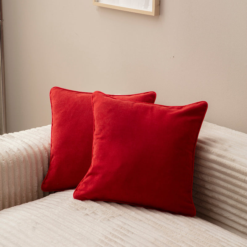 Red velvet square cushion cover 43x43 cm on cream sofa – modern home décor accessory.”