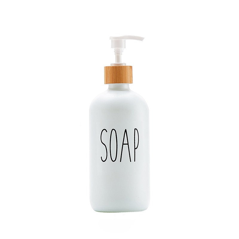 White soap dispenser with bamboo accent and minimalist text design