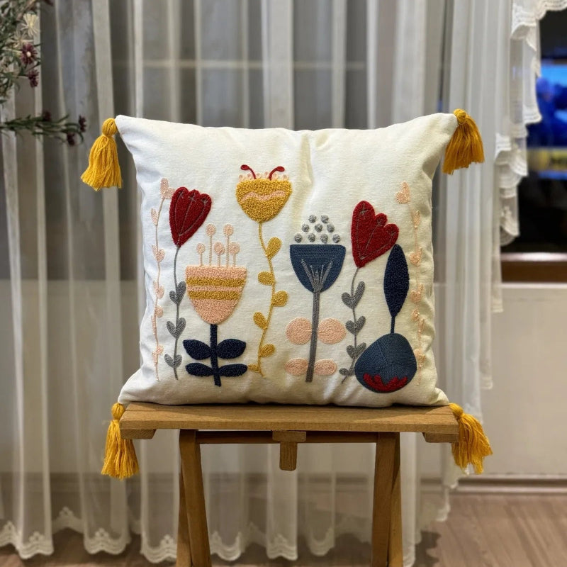 Contempo Floral Collection square embroidered cushion cover with yellow tassels, featuring tulip and heart floral motifs in red, yellow, and blue – 43x43 cm decorative pillow