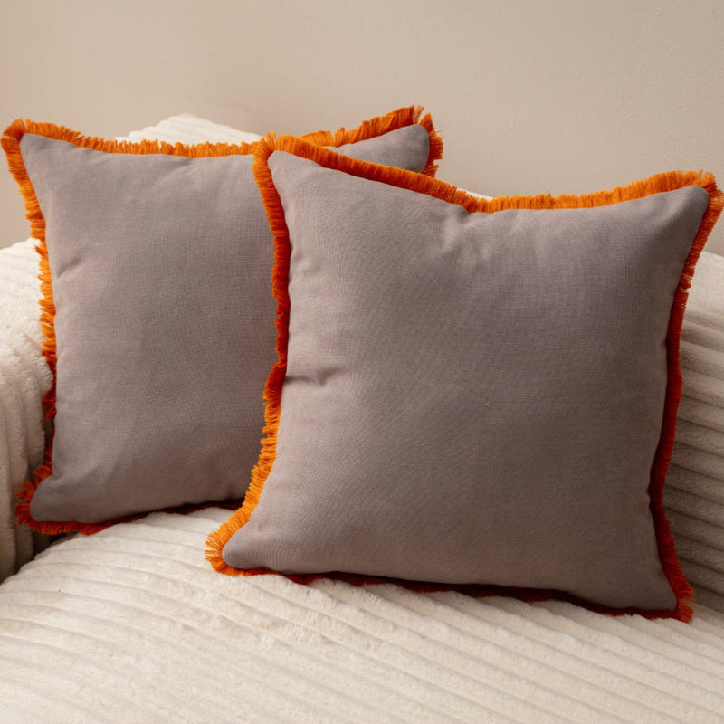 Taupe cushion cover with orange fringe on beige sofa – 43x43 cm
Pair of taupe and orange fringe cushions styled for living room décor
Close-up of taupe cushion with orange trim edges
Decorative pillow in taupe with bold orange fringe