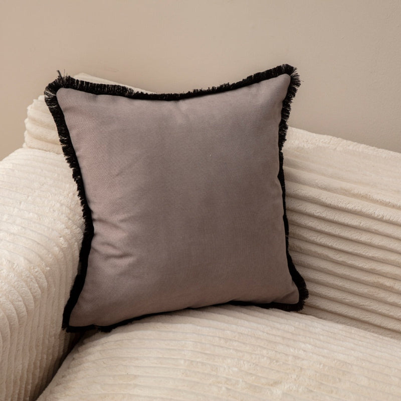 Taupe cushion cover with black fringe on sofa – 43x43 cm
Pair of taupe and black fringe cushions styled for modern décor
Close-up of taupe cushion with bold black trim edges
Decorative pillow in taupe with black fringe for living room décor