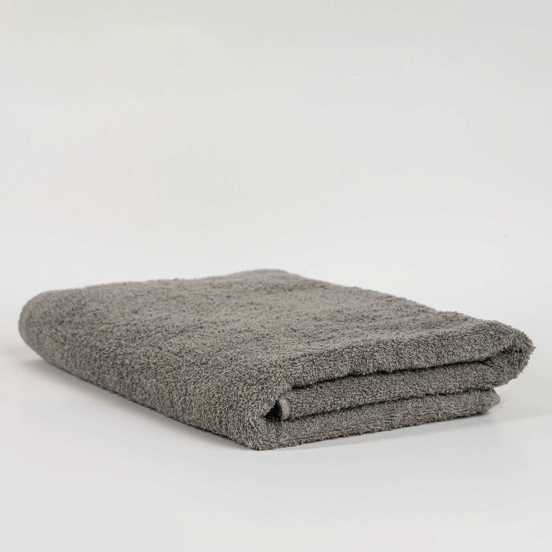 Absorbent stone grey cotton towel folded neatly.