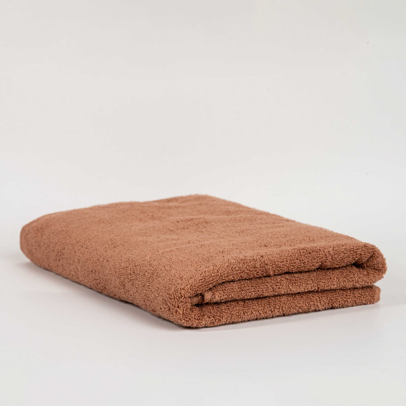 Absorbent mocca cotton towel folded neatly.