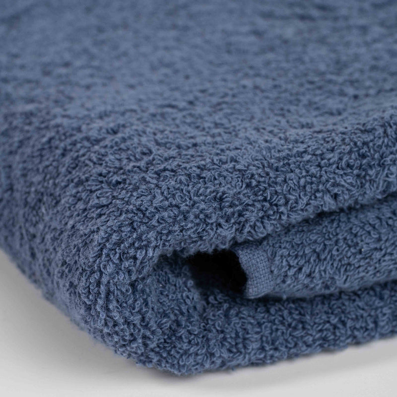 Absorbent indigo blue cotton towel folded neatly.