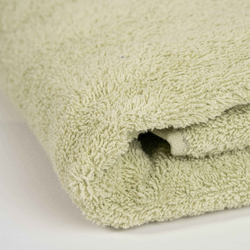 Absorbent aqua green cotton towel folded neatly.