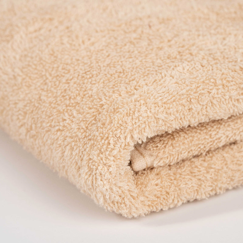 Absorbent terracotta brown cotton towel folded neatly.