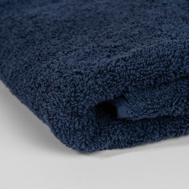 Absorbent midnight blue cotton towel folded neatly.