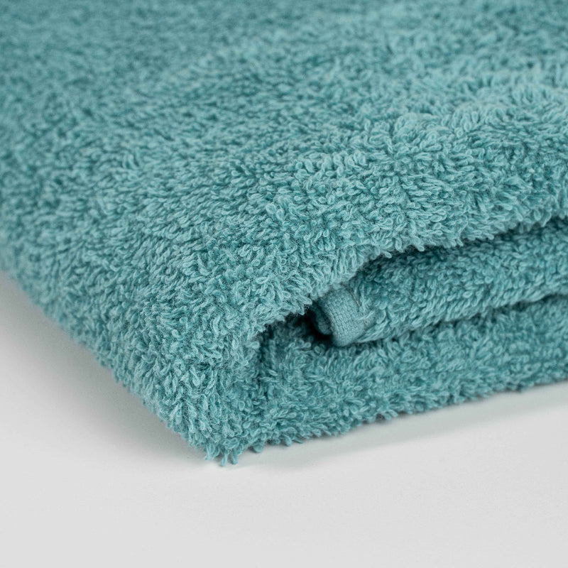 Absorbent pastel green cotton towel folded neatly.