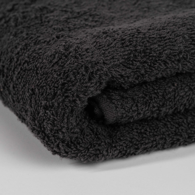 Absorbent dark grey cotton towel folded neatly.