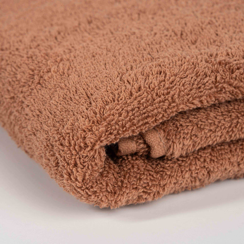 Absorbent mocca cotton towel folded neatly.