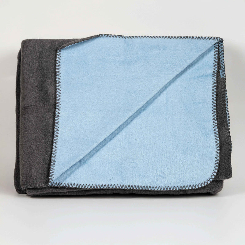 Double-face fleece blanket in pink and grey draped on chair