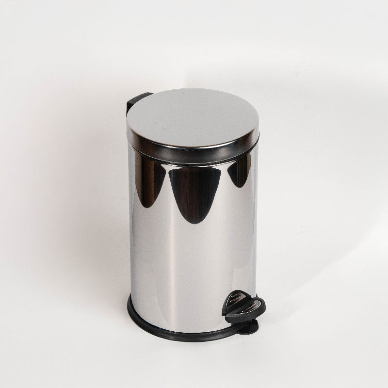 Stainless steel pedal bin next to toilet in modern bathroom