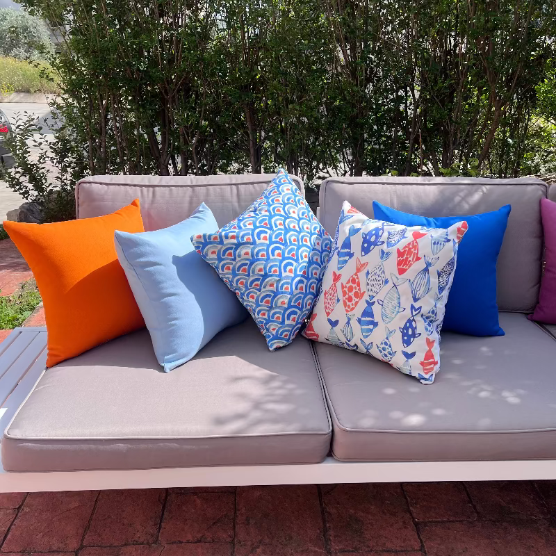 Colorful fish pattern cushion cover with blue and orange marine design on white decorative pillow