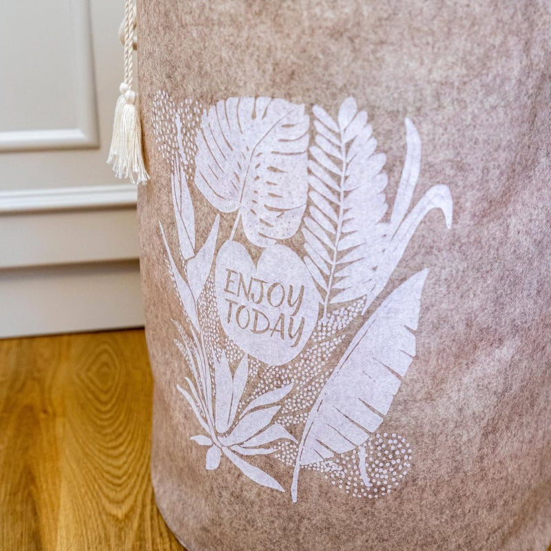 Close-up of purple felt laundry basket with “Enjoy Today” print
Round felt laundry basket with rope handles in bathroom
Stylish felt laundry bin with drawstring cover
Purple storage hamper with modern leaf design
