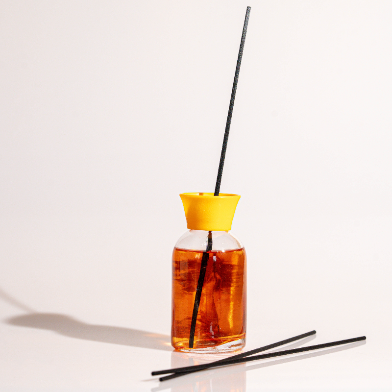 Elegant glass Peach reed diffuser with fragrance oil and natural sticks for home fragrance