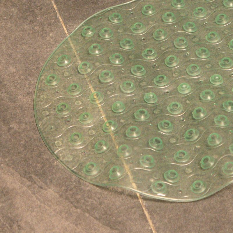 Green anti-slip capsule rubber shower mat on gray tiled bathroom floor