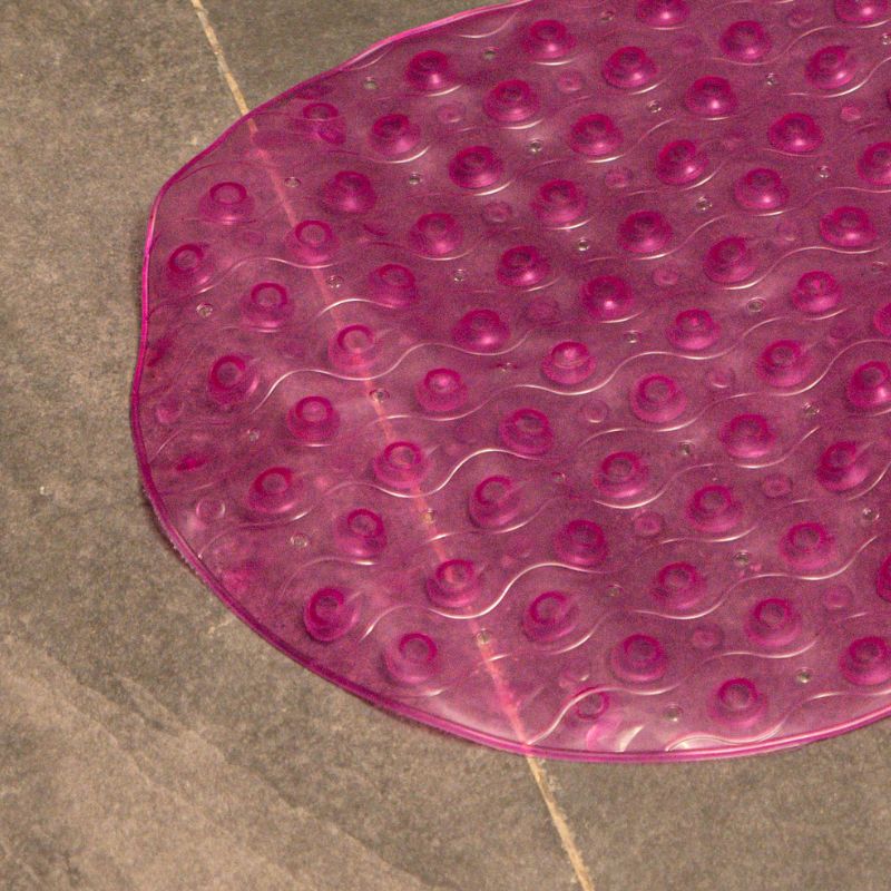 Lilac anti-slip capsule rubber shower mat on gray tiled bathroom floor
