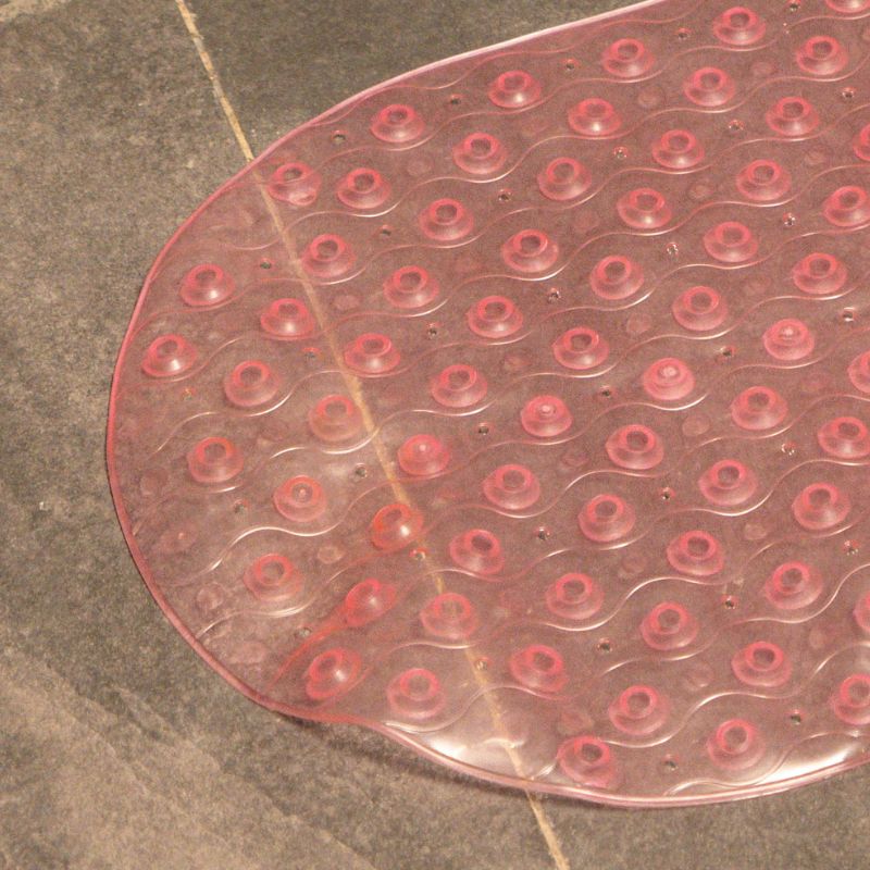 Soft pink anti-slip capsule rubber shower mat on gray tiled bathroom floor