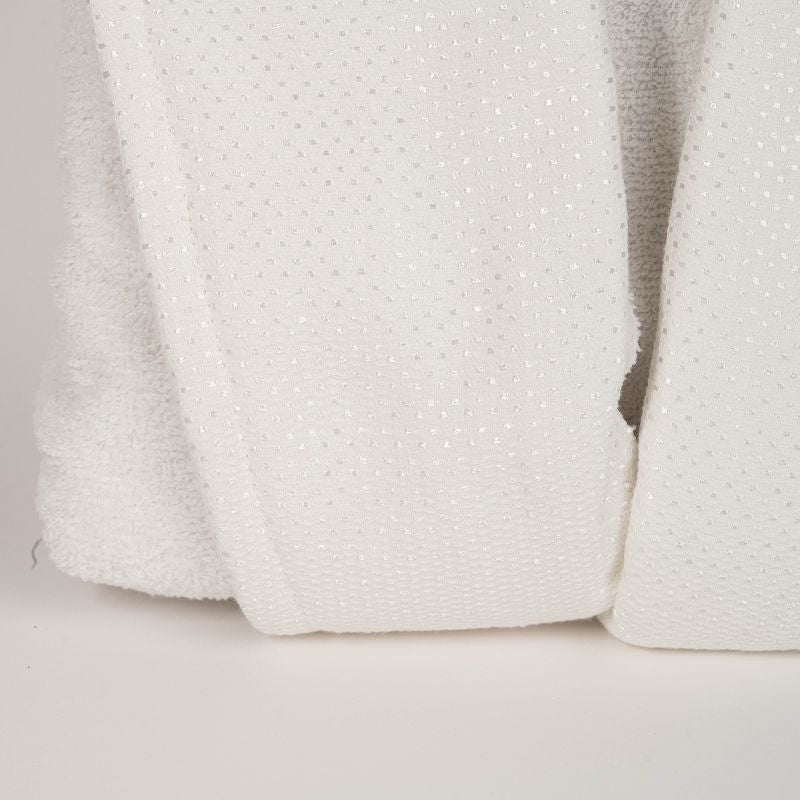 Unisex cotton terry bathrobe with shawl collar and waist belt, worn by woman near window in natural light