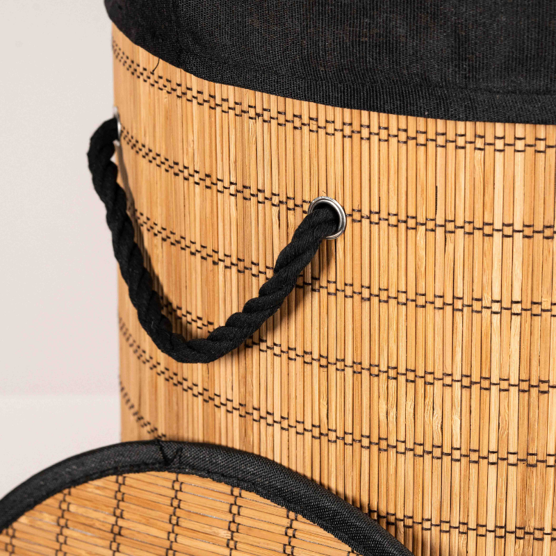 Round bamboo laundry basket with lid and black fabric lining.