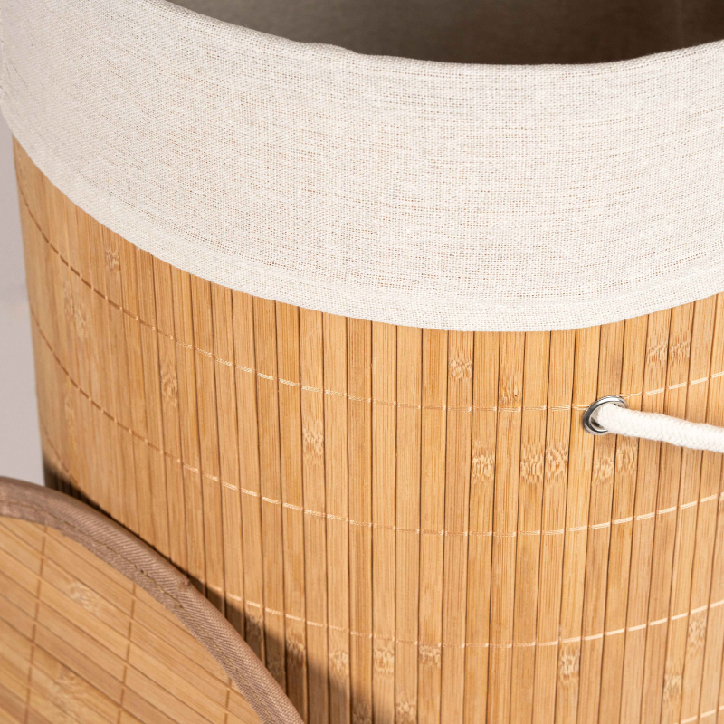 Round bamboo laundry basket with lid and off-white fabric lining.