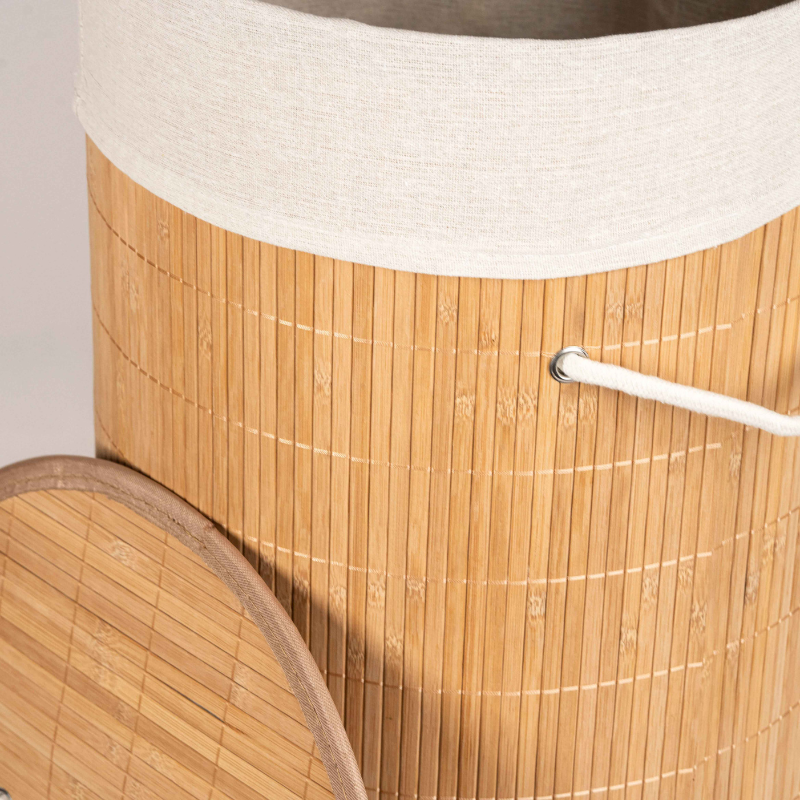 Round bamboo laundry basket with lid and off-white fabric lining.