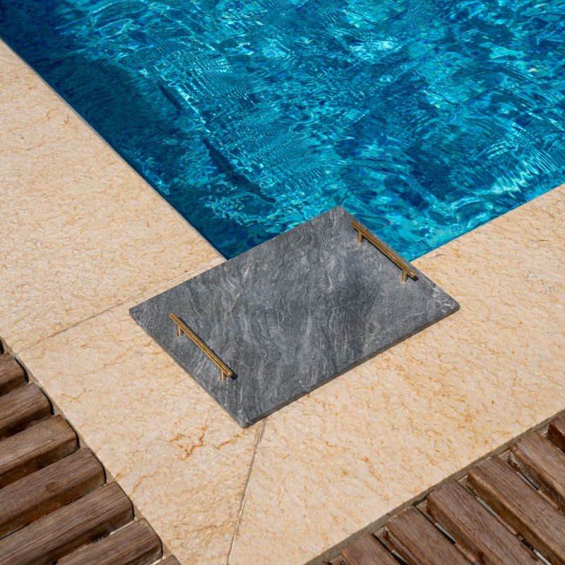 slate marble tray with brass handles placed poolside – luxury stone serving tray
