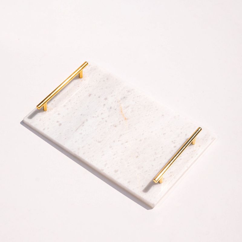 white marble tray with brass handles next to pool – luxury serving tray
