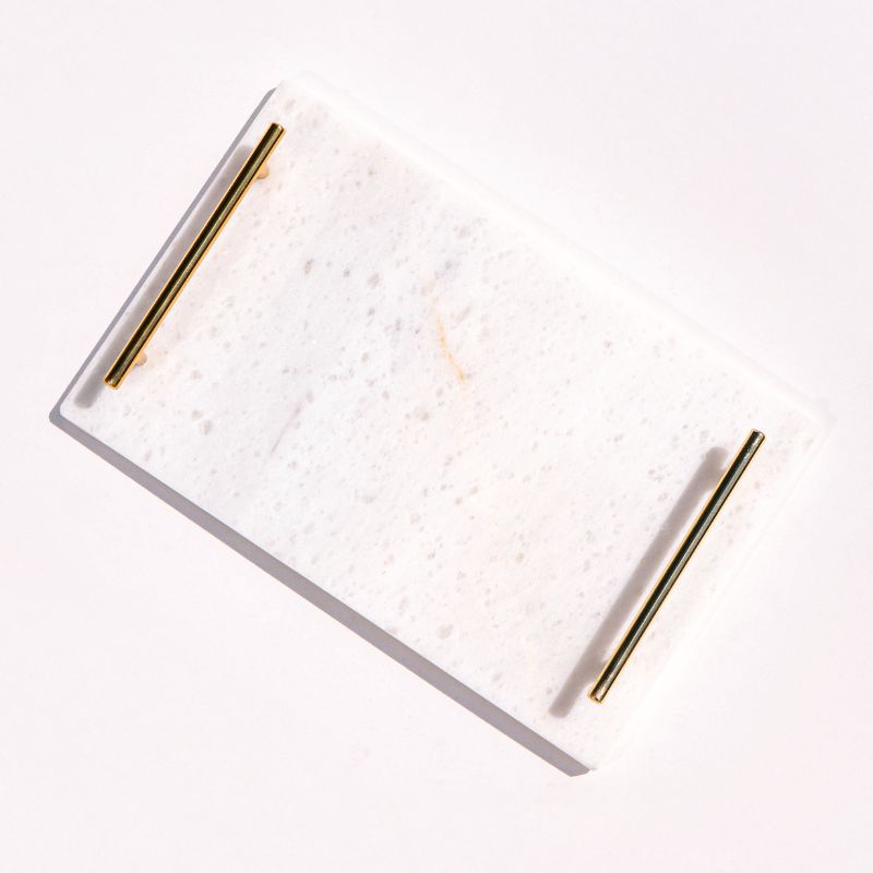 white marble tray with brass handles next to pool – luxury serving tray