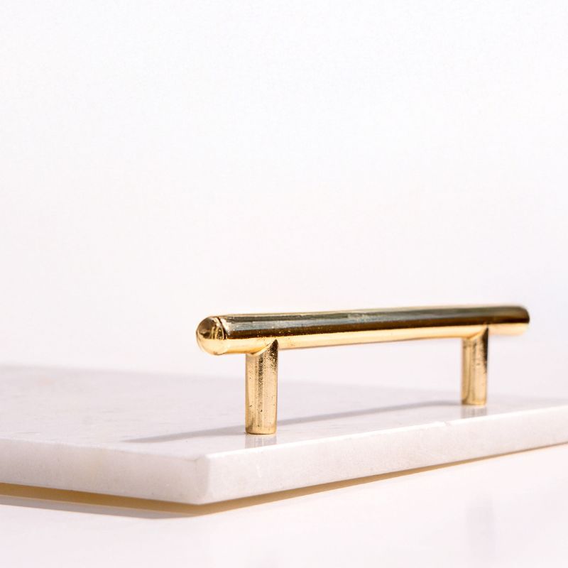 white marble tray with brass handles next to pool – luxury serving tray