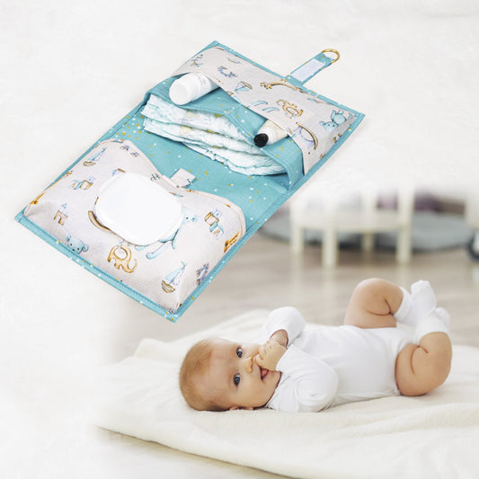 Foldable baby changing mat with built-in storage pockets and diapers, shown above a baby lying on a soft mat