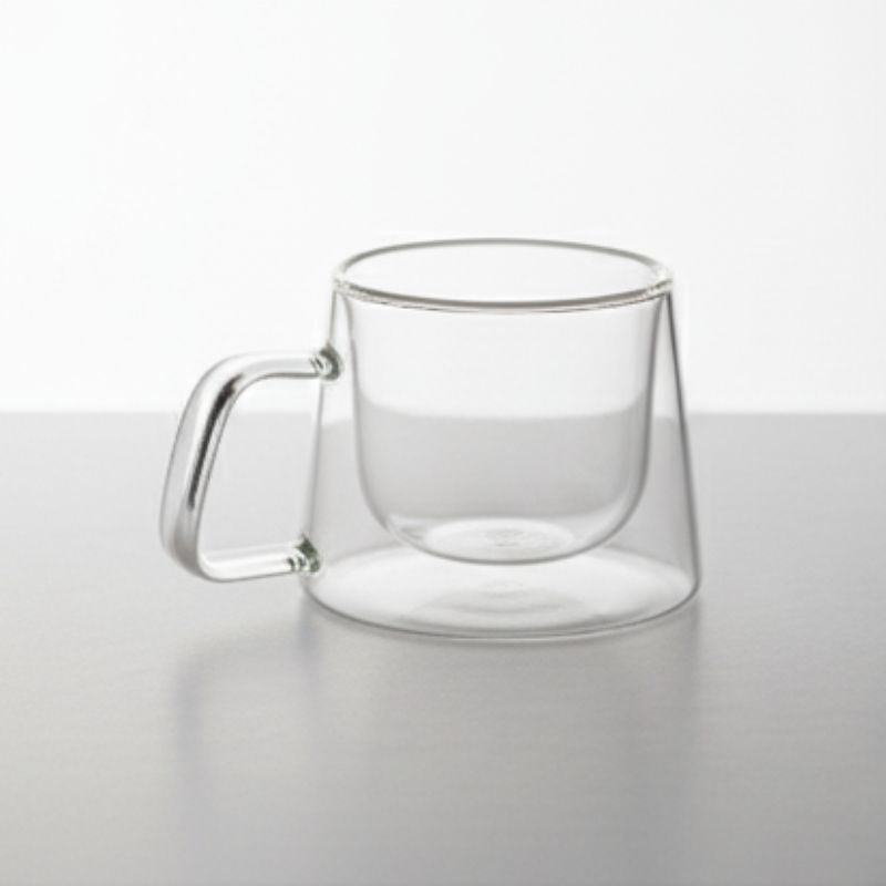 Double-wall glass coffee mug with handle, empty
Heat-resistant clear glass coffee cup for espresso or tea
Modern borosilicate glass mug on white background
Transparent insulated glass mug with ergonomic handle