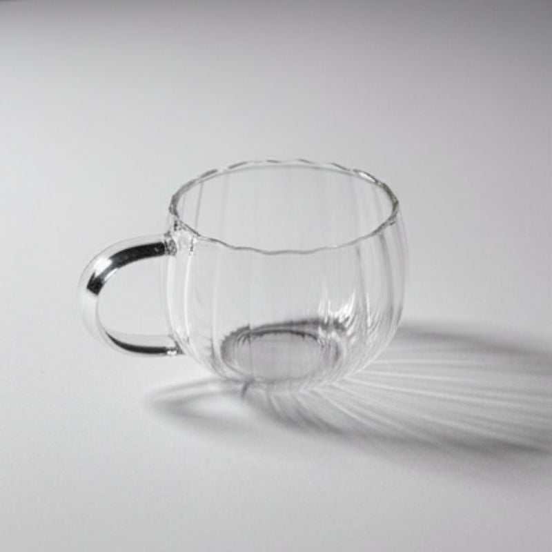 “Ribbed clear glass cup with handle – pumpkin shaped transparent teacup”
“Elegant ribbed glass coffee cup with clear handle on white background”
“Transparent pumpkin-style glass mug for tea, coffee, or desserts”
“Modern ribbed glassware with handle – versatile teacup design”
“Clear ribbed glass cup showcasing minimalist drinkware style