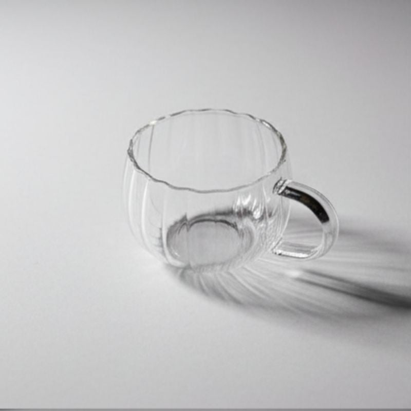 “Ribbed clear glass cup with handle – pumpkin shaped transparent teacup”
“Elegant ribbed glass coffee cup with clear handle on white background”
“Transparent pumpkin-style glass mug for tea, coffee, or desserts”
“Modern ribbed glassware with handle – versatile teacup design”
“Clear ribbed glass cup showcasing minimalist drinkware style