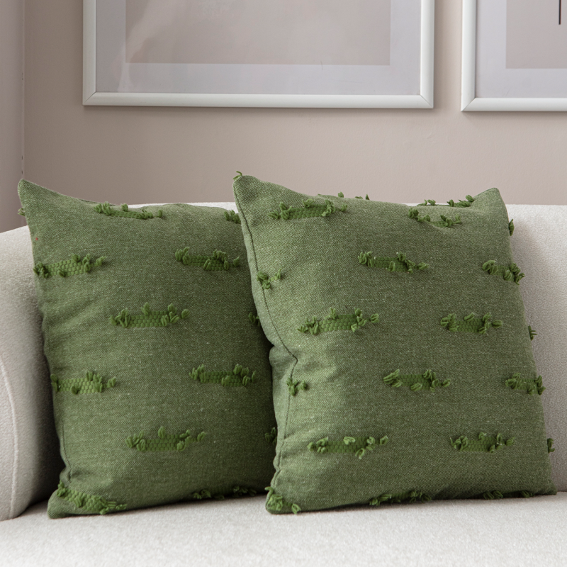 Olive green textured woven throw pillow on light sofa – decorative cushion with horizontal tufted details
