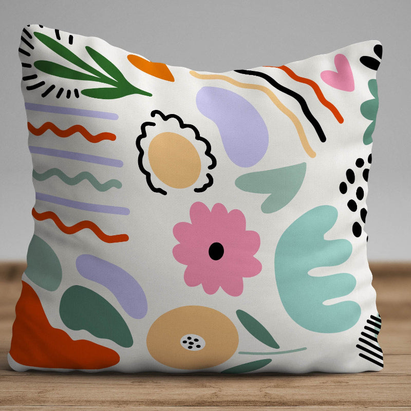 White cushion with colorful abstract shapes in a modern artistic pattern