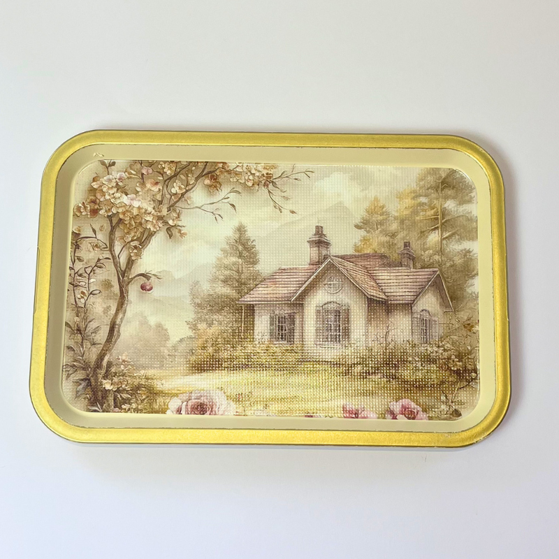 Rectangular serving tray with vintage cottage landscape, floral details, and gold-toned border