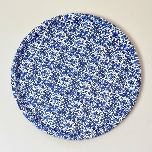 Round blue floral patterned plate on a beige background