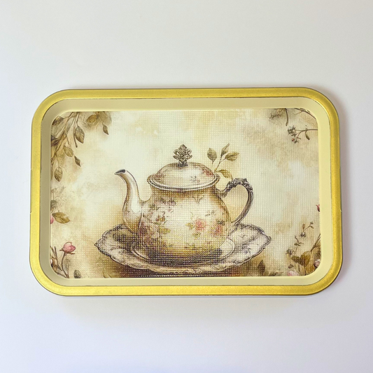 Rectangular serving tray with a vintage teapot illustration, floral details, and gold-toned border