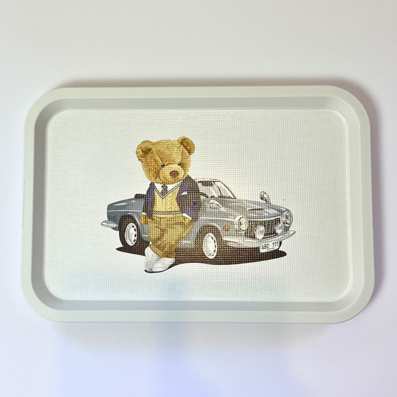 Tray with a teddy bear and car illustration on a white background