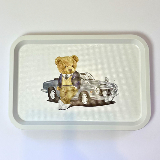 Tray with a teddy bear and car illustration on a white background