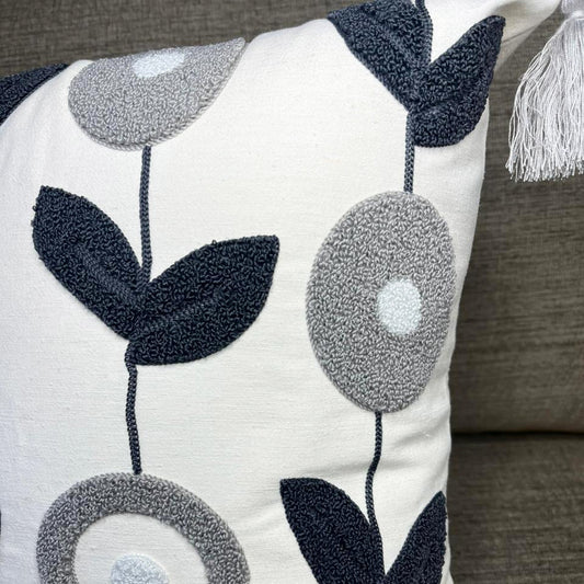 Nordic Bloom cushion cover with navy and grey floral embroidery and tassels