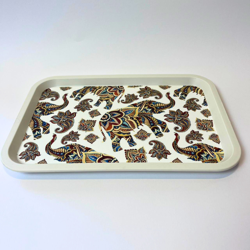 Rectangular serving tray with elephant and paisley-inspired pattern on a light background