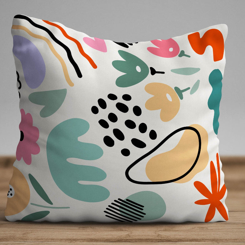 White cushion with pastel abstract shapes in a modern artistic pattern