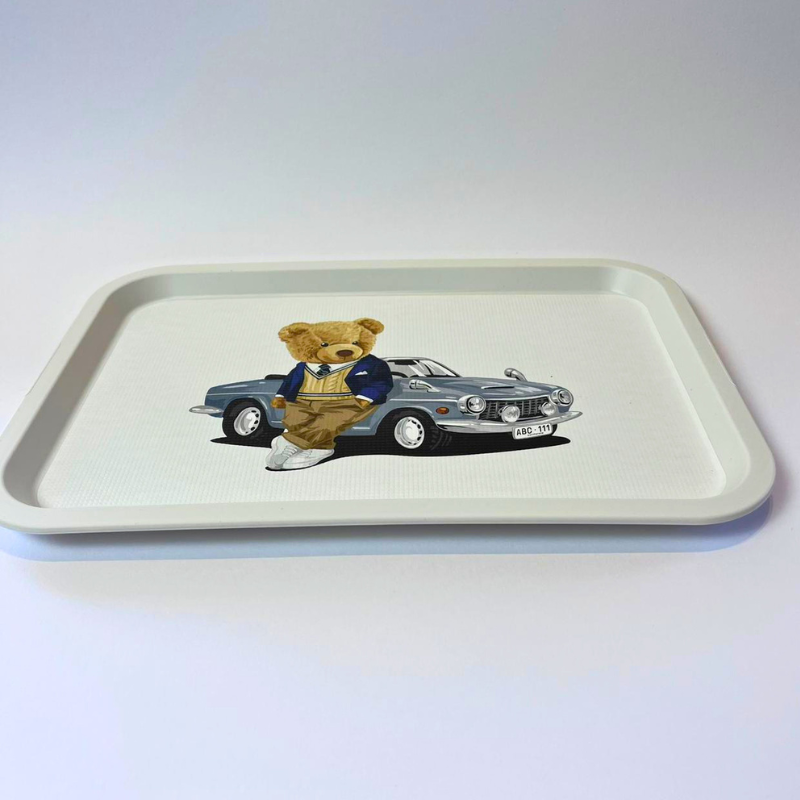 Tray with a teddy bear and car illustration on a white background