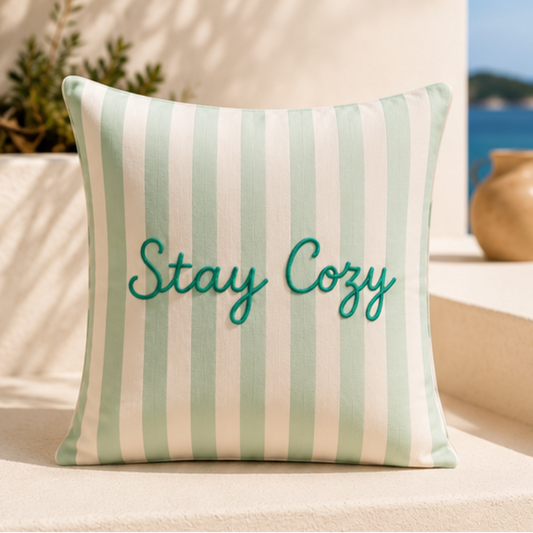 Sage green and white striped decorative cushion cover featuring Stay Cozy text in elegant script lettering