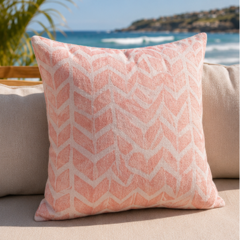Soft pink geometric chevron cushion cover with minimalist pattern on decorative pillow