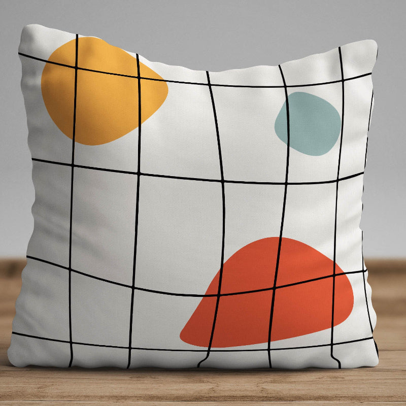 White cushion with black grid lines and abstract colored shapes in a modern geometric design
